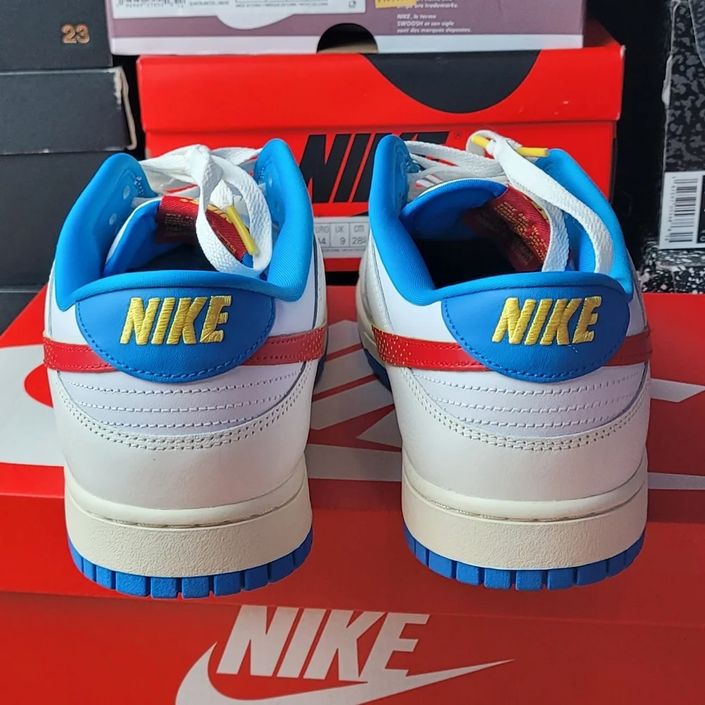 Nike White and Blue Sneakers with Orange Swoosh